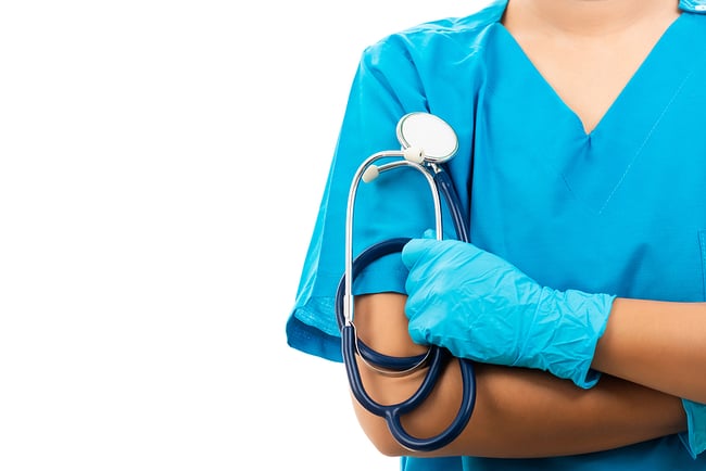 New medical assistant wearing medical gloves holding a stethoscope. 
