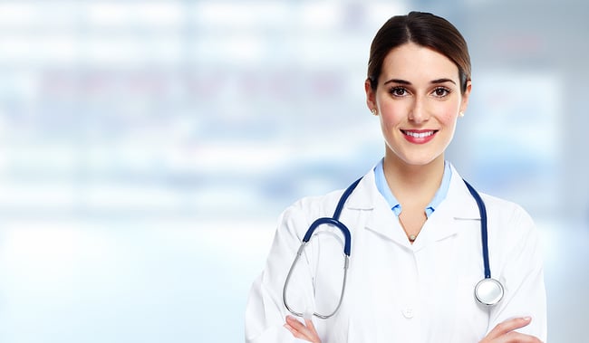 Medical professional standing in a healthcare facility smiling at the camera