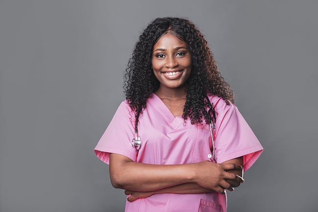 Young medical assistant wearing pink scrubs.