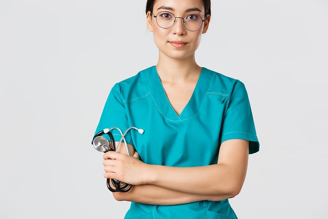 Female medical assistant staring at the camera, slight smile, holding a stethoscope. 