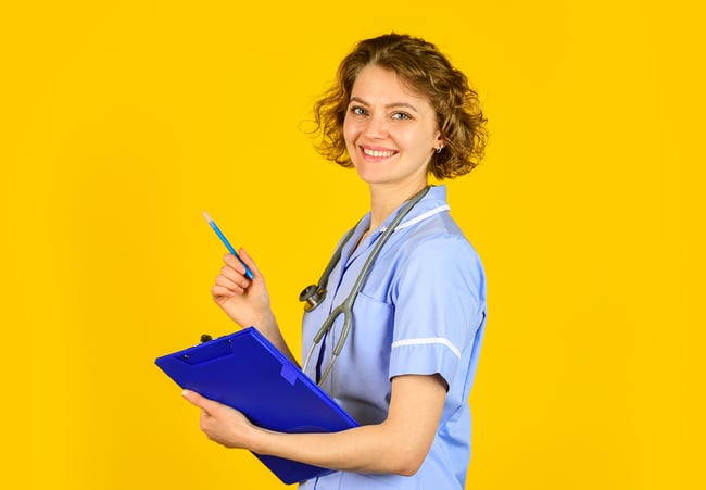 Female medical assistant with a blue clipboard.