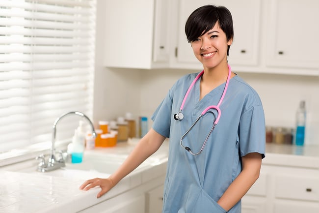 Smiling nursing student standing in a medical office.